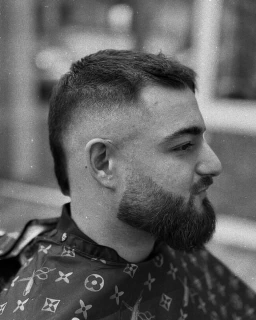 Black-and-white side profile of a finished haircut and beard.